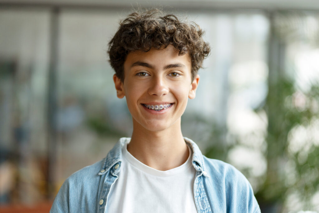 Young male patient smiling with braces from Global Smiles Dental in Indianapolis, Indiana 46237