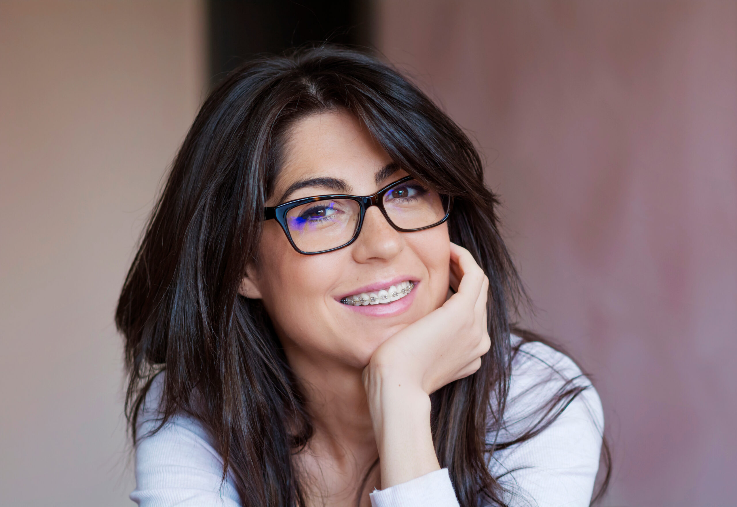 Middle aged female patient smiling with braces from Global Smiles Dental in Indianapolis, Indiana 46237